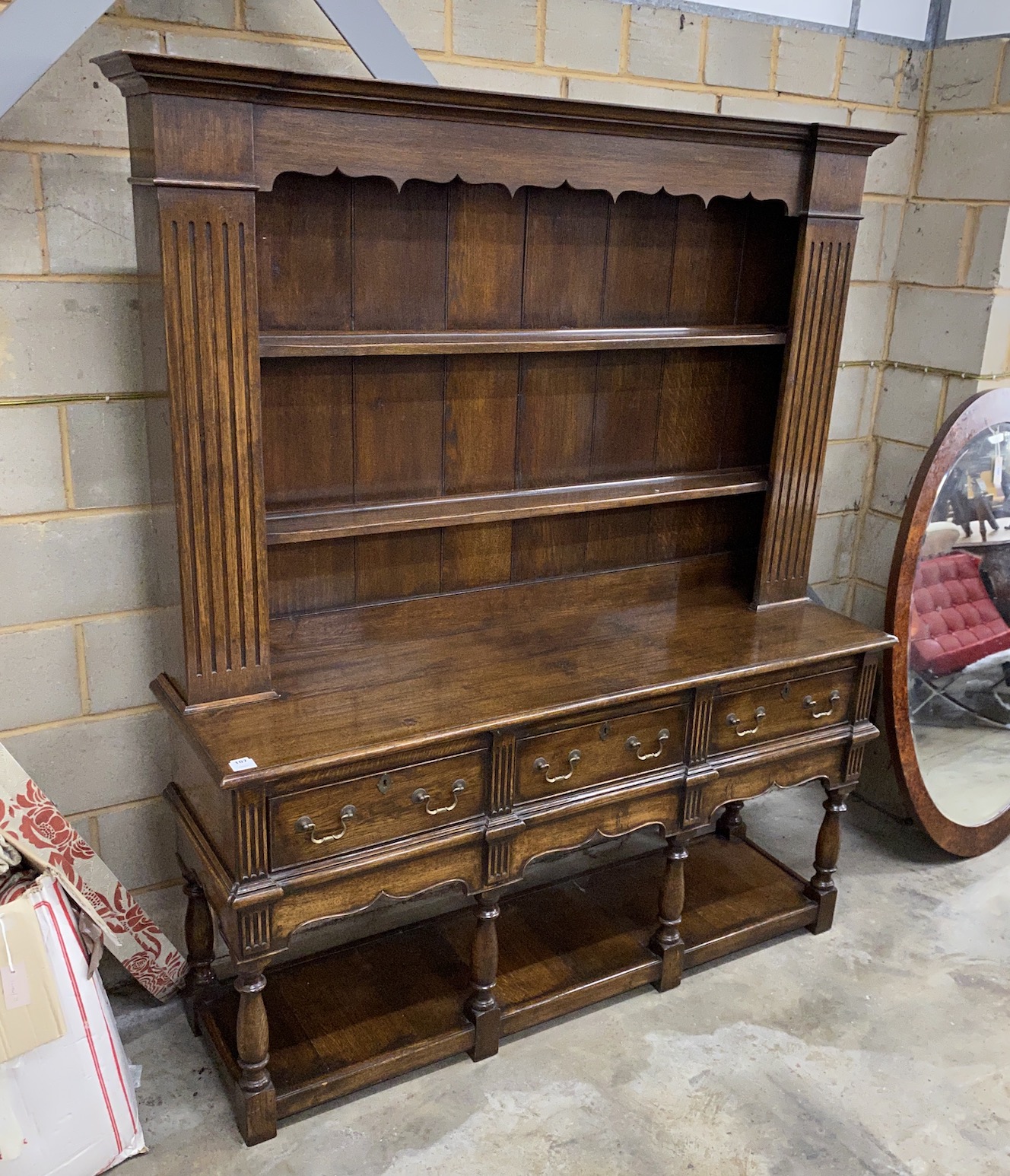 A reproduction 18th century style oak dresser with boarded rack, length 166cm, depth 48cm, height 198cm